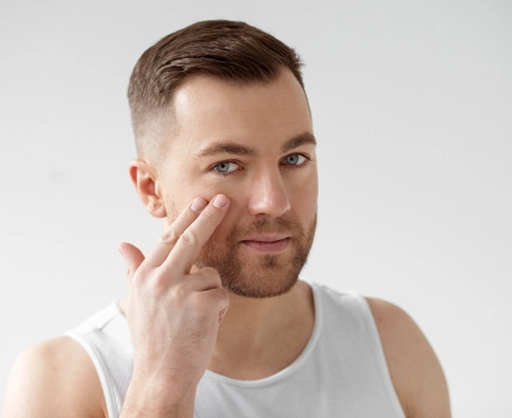 youngman applying anti aging creame